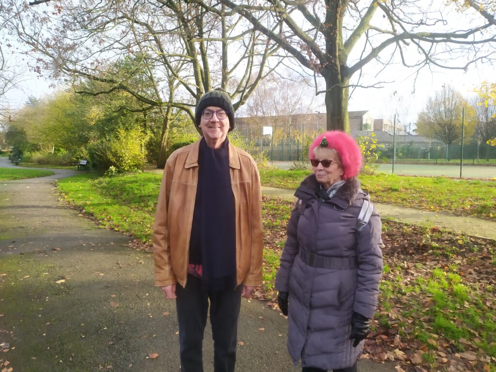 Peter and his volunteer Move Mate, Angie, both in hats in the park
