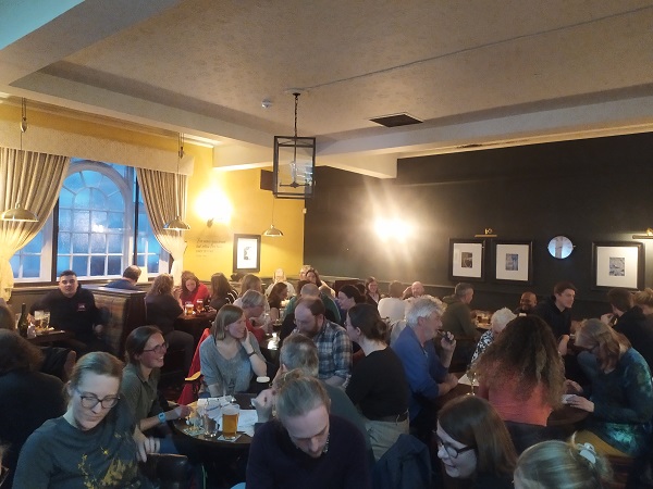 A busy pub full of people quizzing