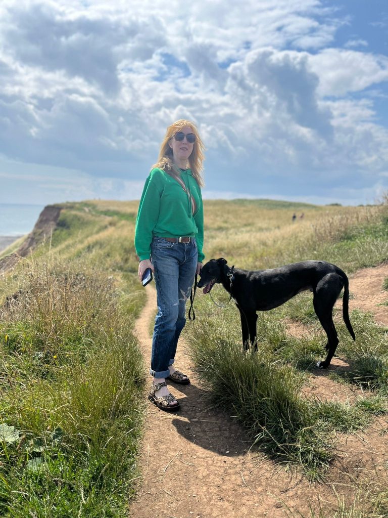 Photo of Elaine with her dog on a walk